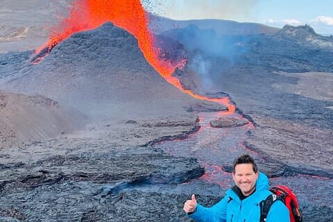 Having the Volcano Fagradalsfjall erupting fresh red lava as a background