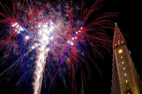 The iconic Hallgrímskirkja Church, illuminated beautifully, serves as a key landmark on the Icelandic New Year's Eve Walking Tour