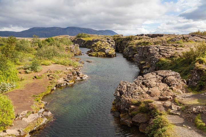 Öxarárfoss is a waterfall situated within Þingvellir National Park in southwest Iceland. The waterfall flows out the river Öxará, cascading in two drops over the cliffs of Almannagjá gorge.