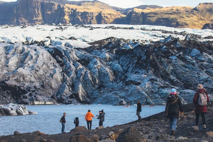 Kayakers paddle up close and hikers explore the glacier, a natural phenomenon.