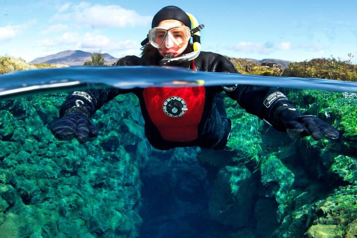 Snorkeler in the clear water of Silfra fissure