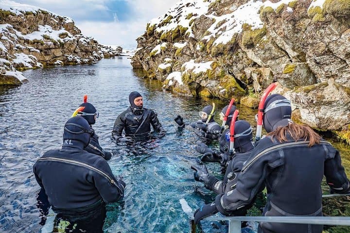 Snorkelers and their guide on the Silfra entry platform