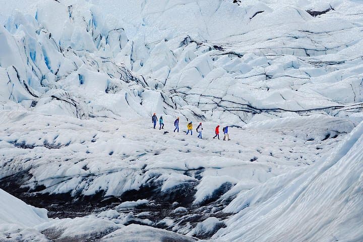 Adventure seekers walk together in the middle of a glacier hike in Skaftafell.