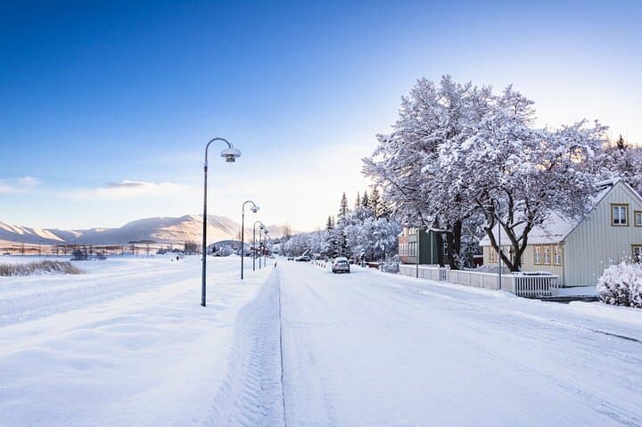 Akureyri transforms into a winter wonderland beneath snowy peaks