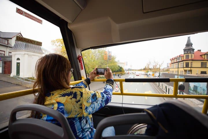 Reykjavík attractions are described on a sightseeing bus with audio commentary.