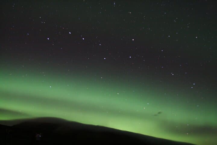 Chasing dreams under Iceland’s glowing sky! The Northern Lights dance above in waves of green and gold — pure Arctic magic.